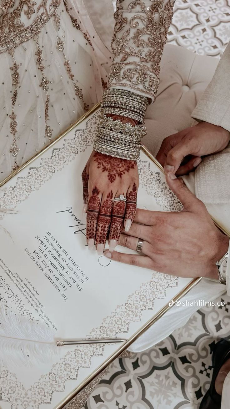 Wedding invitation card with mehendi-adorned hands